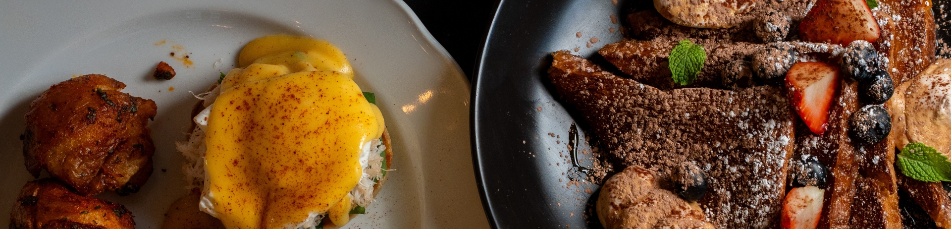 Multiple plates of breakfast food on a table