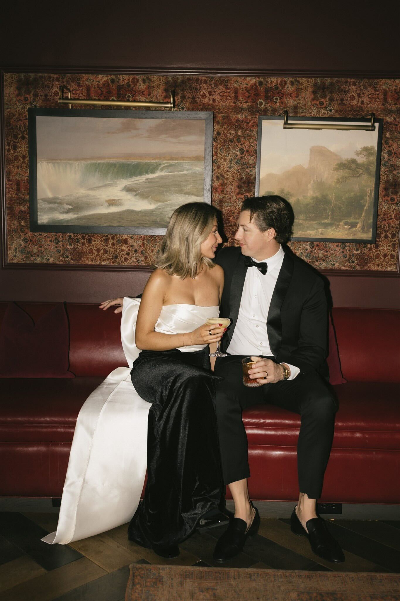 a man and a woman look lovingly at each other in a dark speak easy